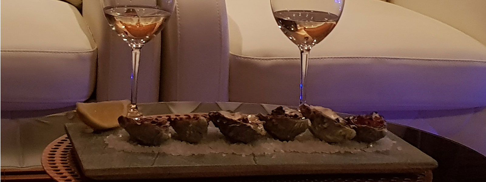Oysters and wine in yacht cabin